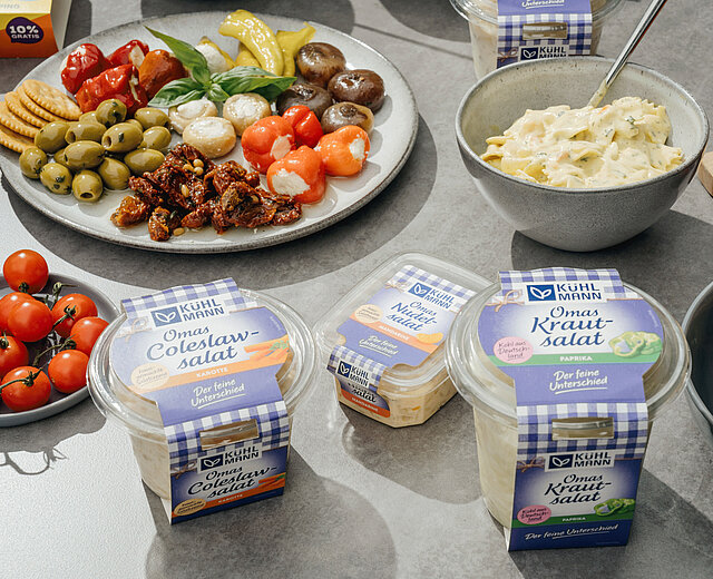 Kühlmann products, plated and packaged, on a table.