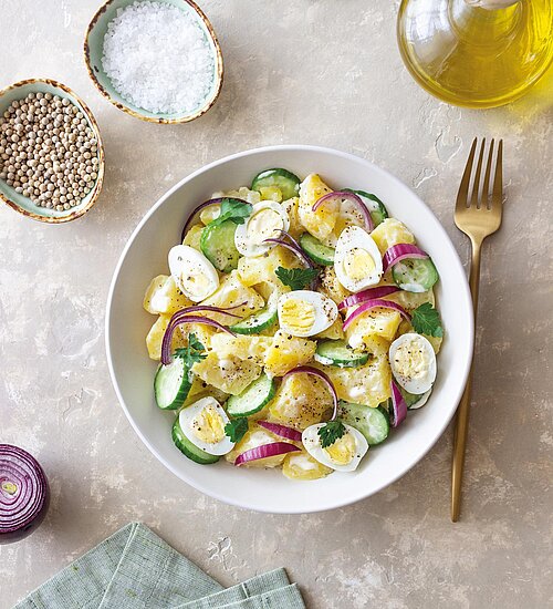 Salad with potatoes, cucumber, onion and eggs. Healthy food. Vegetarian food.