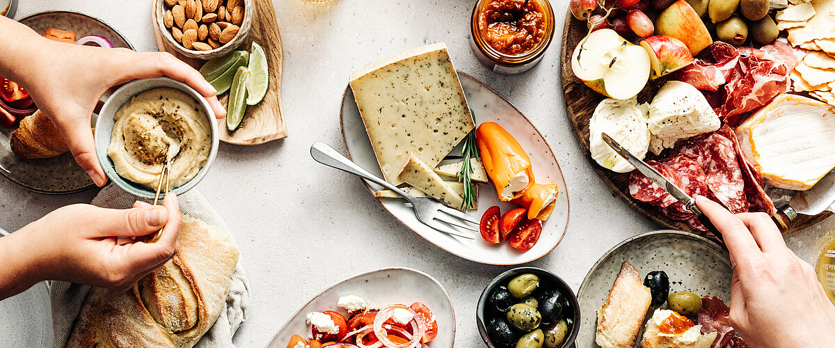 Women's hands at a table with Mediterranean products